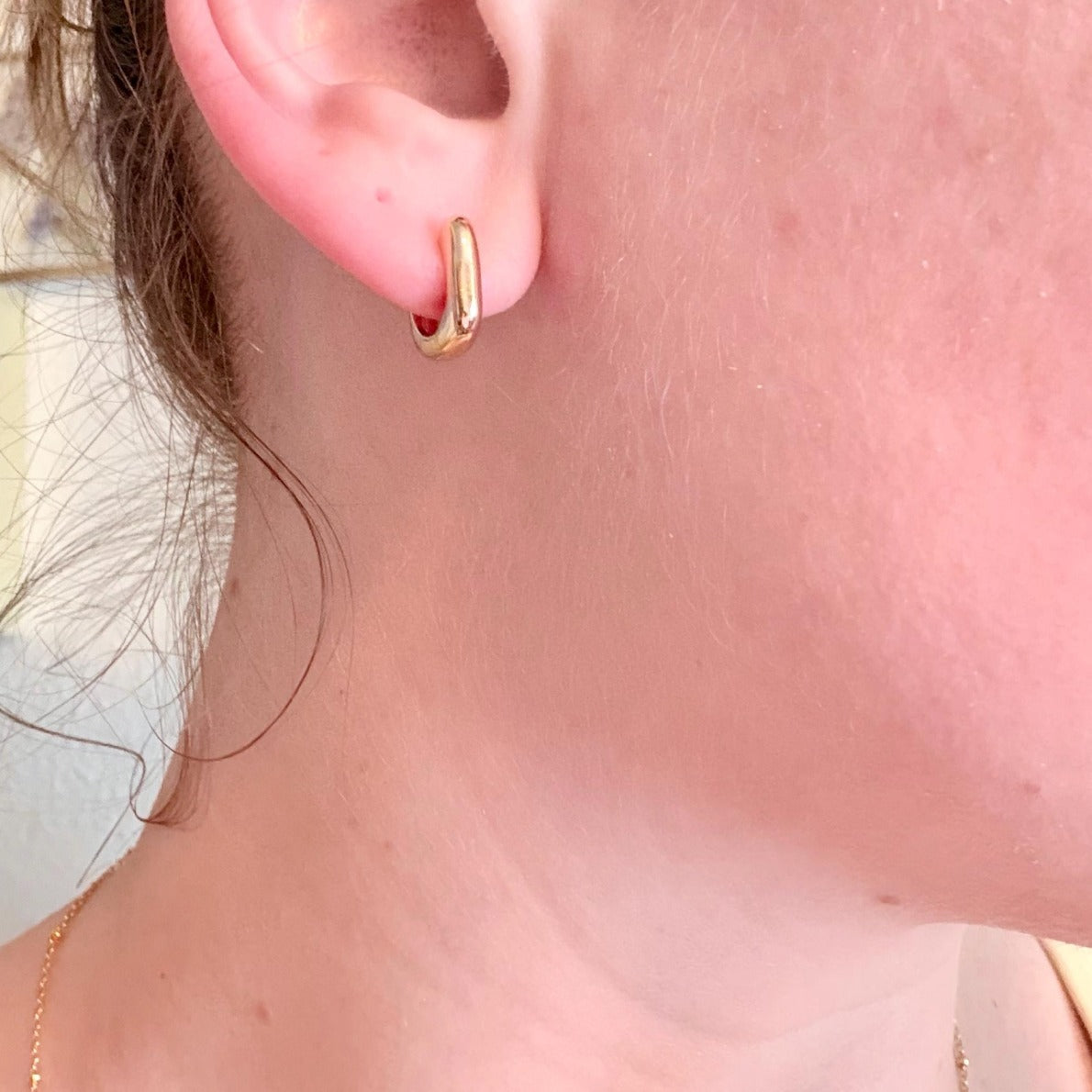Customer wearing Belle Oro gold hoops